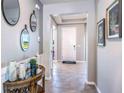 Inviting entryway with tile flooring, decorative mirrors, and modern light fixtures at 10645 Bridgegate Heights Loop, San Antonio, FL 33576