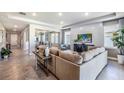 Spacious living room with open floor plan, large windows, and modern decor at 10645 Bridgegate Heights Loop, San Antonio, FL 33576