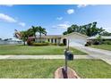 Charming single-story home featuring lush landscaping, a well-manicured lawn, and a classic mailbox at 12933 90Th Ave, Seminole, FL 33776