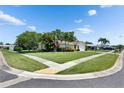 Corner lot home featuring a spacious lawn, mature trees, and traditional architecture in a residential area at 12933 90Th Ave, Seminole, FL 33776