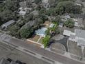 A charming home and its lot are outlined in this aerial view, showcasing proximity to surrounding areas at 14049 12Th St, Dade City, FL 33525