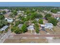 Aerial view of a home nestled among lush trees with a detached garage in a charming neighborhood at 14049 12Th St, Dade City, FL 33525