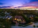 Luxurious estate aerial view highlighting the impressive home, surrounded by lush greenery and waterfront views at 1600 Magnolia Rd, Belleair, FL 33756