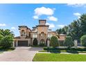 Beautiful home with meticulous landscaping, brick driveway and gated entrance at 1600 Magnolia Rd, Belleair, FL 33756