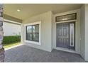 Welcoming front porch with stylish stone accents, and a beautifully designed front door at 1741 Cherry Walk Rd, Lutz, FL 33558