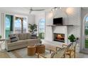 Bright living room featuring a white brick fireplace, comfortable seating, and ocean views at 17960 Gulf Blvd # 225, Redington Shores, FL 33708