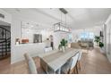 Bright and modern open space with spiral staircase, kitchen, dining and living areas at 17960 Gulf Blvd # 225, Redington Shores, FL 33708