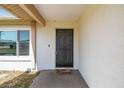 Front door with a black security screen and a cozy 'Home Sweet Home' welcome mat at 2071 Linwood Ave, Spring Hill, FL 34608
