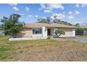 Quaint single-story home featuring an attached garage, and a driveway with space for parking at 2071 Linwood Ave, Spring Hill, FL 34608
