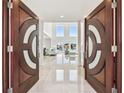 Grand foyer featuring high ceilings, tile flooring, and an open floor plan with water views at 2233 Donato Dr, Belleair Beach, FL 33786