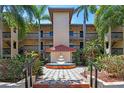 Condo building with a beautiful courtyard with a tiered fountain and lush landscaping at 2400 Feather Sound Dr # 735, Clearwater, FL 33762