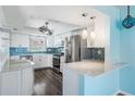 Modern kitchen with stainless steel appliances, granite countertops, and stylish tile backsplash at 2700 Bayshore Blvd # 511, Dunedin, FL 34698