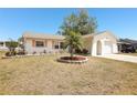 Well-maintained single Gathering home featuring mature landscaping with palm trees on a sunny day at 2702 Ochatilla Rd, Holiday, FL 34691