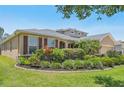 Charming home featuring manicured landscaping, a well-maintained lawn, and a welcoming facade at 2803 130Th E Ave, Parrish, FL 34219