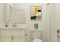 Neutral bathroom with a granite countertop, white cabinetry, framed art, and shower with bright lighting at 31793 Griffin Sands Ln, San Antonio, FL 33576