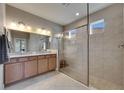 Modern bathroom featuring a glass-enclosed shower, granite countertop, and neutral tile flooring at 32628 Harmony Oaks Dr, Wesley Chapel, FL 33545