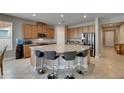 Spacious kitchen featuring granite countertops, stainless steel appliances, and breakfast bar seating at 32628 Harmony Oaks Dr, Wesley Chapel, FL 33545