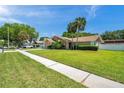 Inviting single-story home boasts lush green lawn, mature trees and a charming exterior at 3439 Northridge Dr, Clearwater, FL 33761