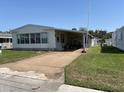 Well-maintained single-story home with carport and easy access driveway at 35804 Brisa Dr, Zephyrhills, FL 33541