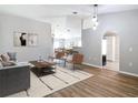 Comfortable living area with wood-look floors, neutral decor, connecting seamlessly to the dining area at 36144 Markree Castle Ave, Dade City, FL 33525