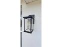 A stylish, updated exterior light fixture against a textured wall at 3914 W Cleveland St, Tampa, FL 33609