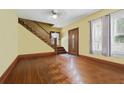 Inviting entryway featuring hardwood floors, staircase, decorative front door, and natural light from the windows at 4100 1St S Ave, St Petersburg, FL 33711