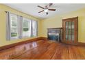 Bright living room with hardwood floors, fireplace, ceiling fan, large windows and classic trim at 4100 1St S Ave, St Petersburg, FL 33711