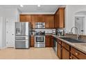 Modern kitchen with stainless steel appliances, granite countertops, and ample cabinetry at 4105 Bismarck Palm Dr, Tampa, FL 33610