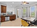 Bright kitchen with stainless steel appliances, granite countertops, and a dining table at 4105 Bismarck Palm Dr, Tampa, FL 33610