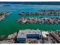 Breathtaking aerial view of waterfront condos with boat docks and turquoise waters in a beautiful neighborhood at 415 Island Way # 511, Clearwater Beach, FL 33767