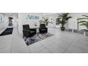 Elegant condo lobby with tile floors, stylish seating, plants, and a modern design at 415 Island Way # 511, Clearwater Beach, FL 33767