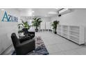 Modern condo lobby area with decorative plants and comfortable seating at 415 Island Way # 511, Clearwater Beach, FL 33767
