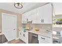 Bright kitchen boasts white cabinets, stainless steel appliances, and modern hardware at 4304 W Arch St, Tampa, FL 33607