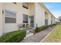 Charming front porch with seating, landscaping, and a blue front door at 4306 La Mora Ct, Tampa, FL 33611