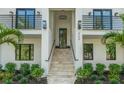 Elegant home entrance with grand staircase, manicured landscaping, and stylish modern accents at 500 E Davis Blvd, Tampa, FL 33606