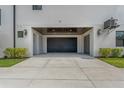 Modern home featuring garage with dark wood ceiling and exterior lights at 500 E Davis Blvd, Tampa, FL 33606