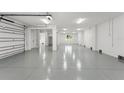 Expansive garage featuring epoxy flooring, ample lighting, and neutral paint at 500 E Davis Blvd, Tampa, FL 33606