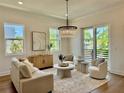 Inviting living room with natural light, elegant chandelier, neutral tones, refined staging, and wood flooring at 500 E Davis Blvd, Tampa, FL 33606