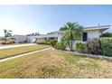 A cozy single-story home with manicured front lawn and a charming palm tree in the front yard at 5877 33Rd N Ave, St Petersburg, FL 33710
