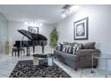 Modern living room with a grand piano, sleek furniture, and stylish decor at 5970 80Th Street North # 206, St Petersburg, FL 33709