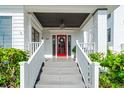 Welcoming front porch with elegant details and lush landscaping at 723 S Brevard Ave, Tampa, FL 33606