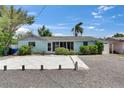 Inviting single-story home with well-maintained gravel yard and lush, mature landscaping at 832 Seabreeze Dr, Ruskin, FL 33570