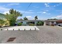 Cozy one-story home with a gravel yard and mature tree, plus tidy side yard at 832 Seabreeze Dr, Ruskin, FL 33570