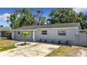 Exterior view of a well-maintained single-Gathering home with a tidy front lawn, and updated paint job at 8345 81St Ct, Seminole, FL 33777