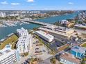 Condominium complex aerial view showcases waterfront location with bridge and surrounding community at 9755 Harrell Ave # 101, Treasure Island, FL 33706