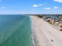 Aerial view of beautiful beach with turquoise water and white sand on a sunny day at 9755 Harrell Ave # 101, Treasure Island, FL 33706