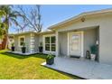 Inviting front porch features modern potted plants and stylish accents leading to the front door at 6914 N Ola Ave, Tampa, FL 33604