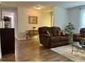 A cozy living room boasts hardwood floors, comfortable seating, and neutral décor, creating a relaxing atmosphere at 10627 Mira Vista Dr, Port Richey, FL 34668