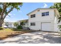 Exterior shot of home with spacious driveway, manicured lawn and beautiful front door at 10716 Donbrese Ave, Tampa, FL 33615