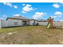 Spacious fenced backyard with a play set, perfect for outdoor activities and Gathering fun at 1102 Wynnmere Walk Ave, Ruskin, FL 33570